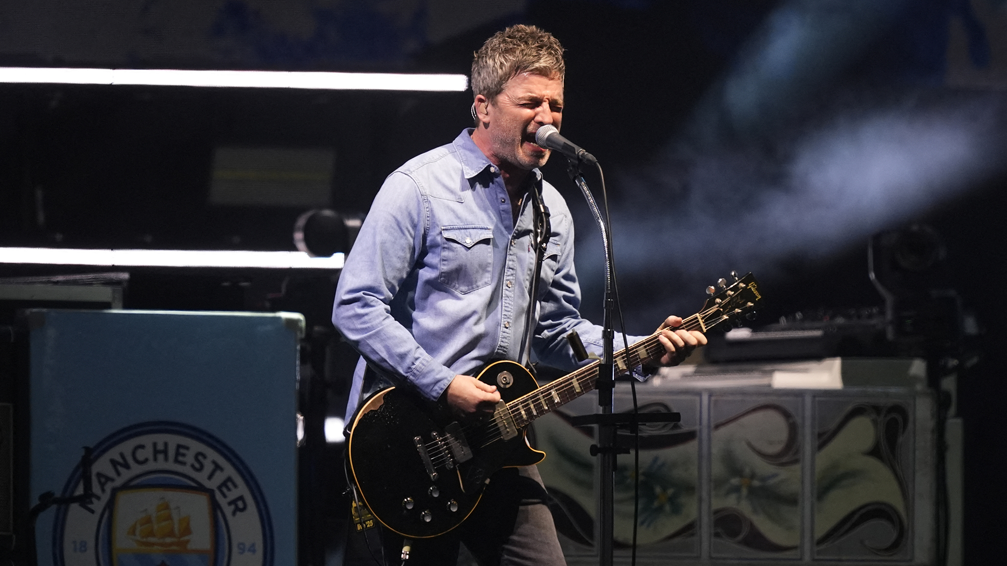 Noel Gallagher, singer and guitarist of British rock band Oasis performs on stage at the Principality Stadium in Cardiff on July 4, 2025, during the opening concert of their highly anticipated reunion tour nearly 16 years after last performing together. Two consecutive nights of concerts at the Principality Stadium in the Welsh capital mark the start of a 41-date run of gigs spanning the world