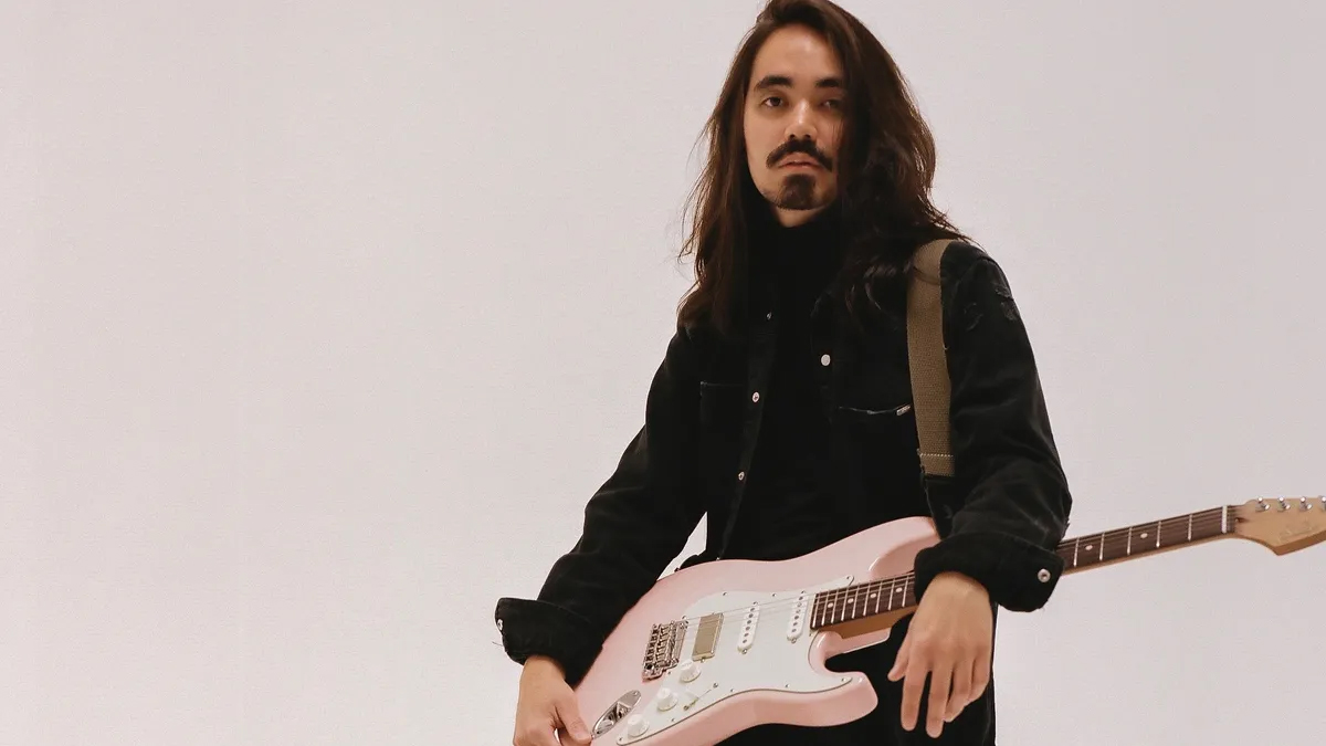 Mateus Asato with his signature Suhr guitar